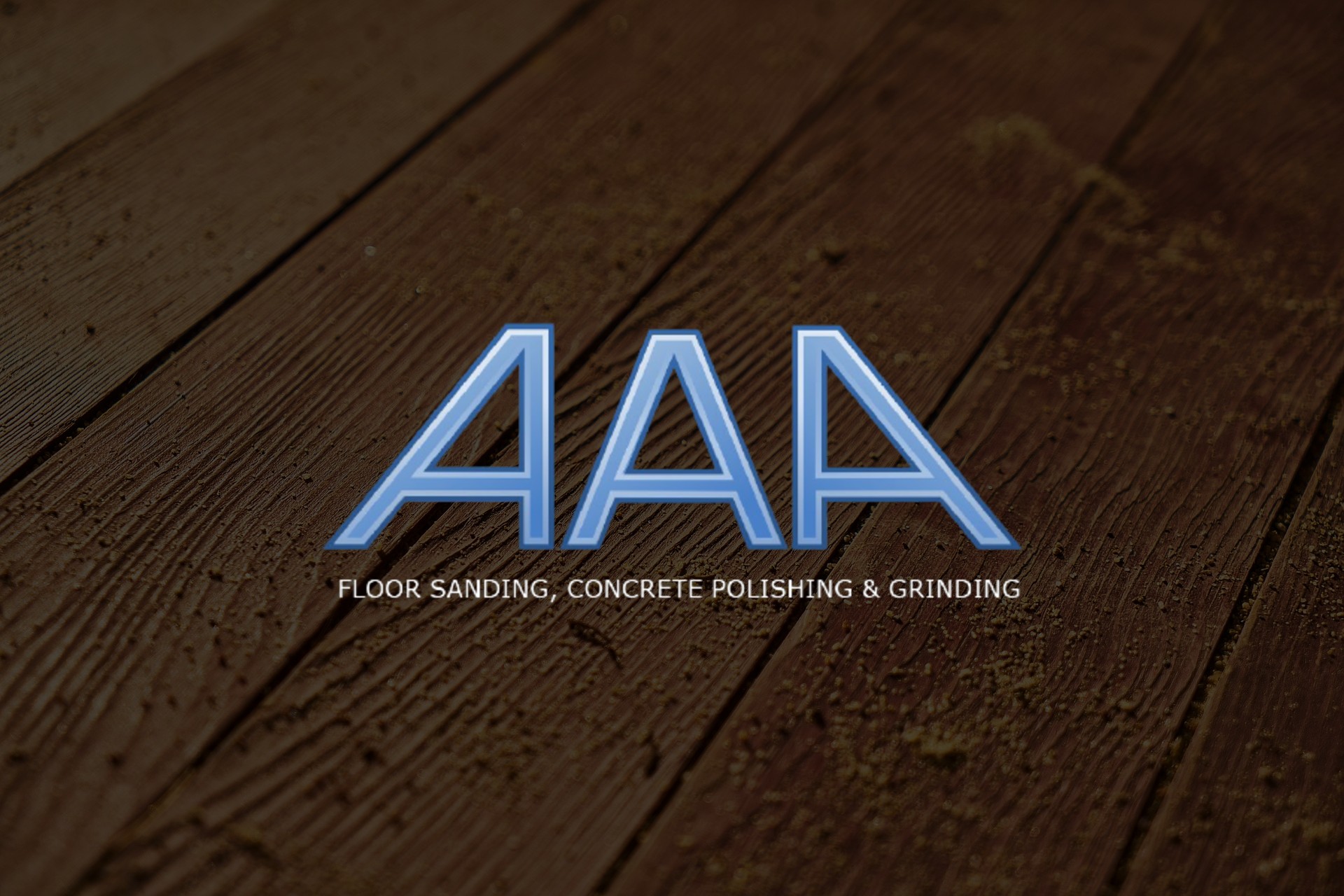 The image features a stylish and modern logo for AAA Floor Sanding, Concrete Polishing & Grinding, prominently placed over a textured wooden floor backdrop. The logo is rendered in a sleek blue font, which stands out against the darker brown of the wood. The visual emphasis on flooring aligns well with the company's services, showcasing their expertise in floor-related solutions. The background indicates a cozy, professional atmosphere that could attract customers looking for reliable flooring services.